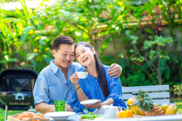 Middle asian couple with food and drink picnic in green park