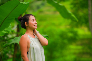 outdoors isolated lifestyle portrait of young attractive and happy Asian Chinese tourist woman enjoying relaxed the beautiful view of tropical rice terrace smiling