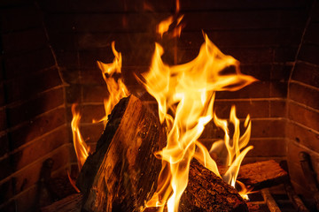 Christmas time. Wood burning in a cozy fireplace at home