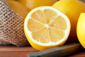 Fresh ripe lemon in burlap sack on table