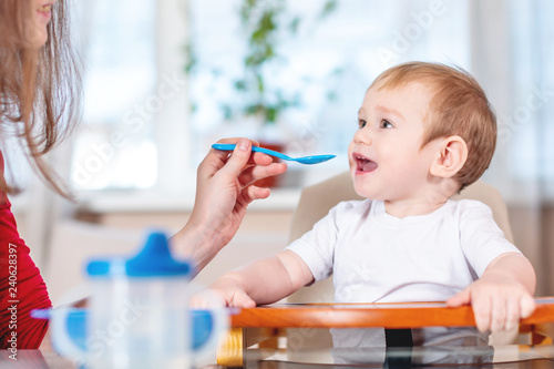 baby holding spoon