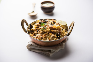 Keema or Kheema Biryani - Fragrant and spicy minced lamb or goat or chicken cooked in range of aromatic spices with basmati rice. served in a karahi with curd. selective focus