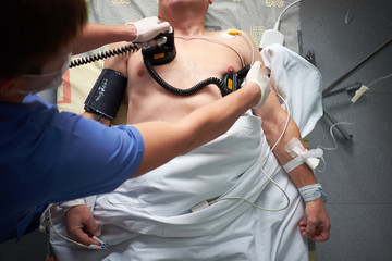 doctor intensivist performs defibrillation to critical patient