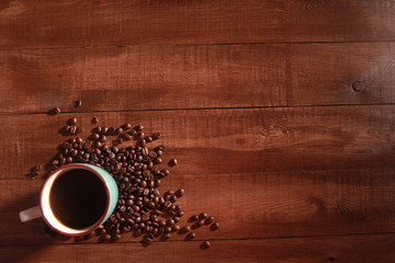 Coffee and beans on vintage wooden table. Coffee break concept. Blue cup, winter drink, espresso, top view