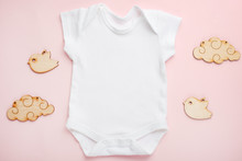 Layout Flat Lay White Baby Bodysuit Shirt, On A Pink Background, For A Girl With Wooden Toys. Mock Up For Design And Placement Of Logos, Advertisements