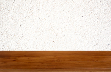 tan wooden table on white background of cement wall textured- can be used for display or montage you