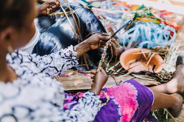 Poster - woman weaving banana leaves in Uganda, Africa