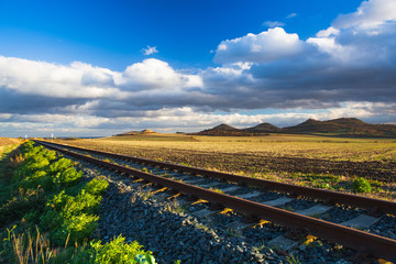 Single railway track at sunset, Czech Republic.