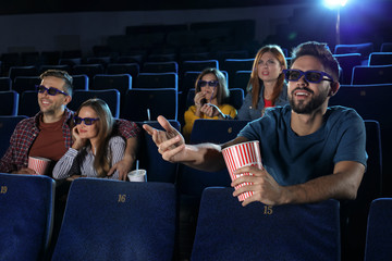 Wall Mural - Young people watching movie in cinema theatre