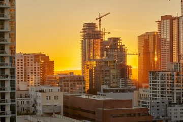 sunset over los angeles california showing construction of skyscrapers