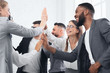 © Prostock-studio - Team achievement, diverse business people giving high five