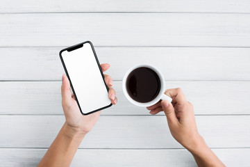 Poster - Hand using smartphone on white wooden background
