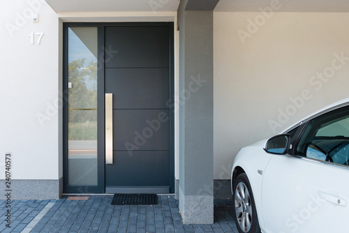 Fotografía Modern house entrance with parking car next to it