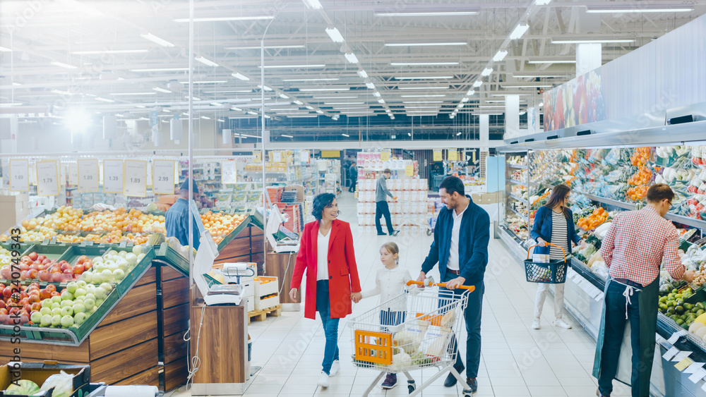 At the Supermarket: Happy Family of Three, Holding Hands, Walks Through Fresh Produce Section of the Store. Father, Mother and Daughter Having Fun Time Shopping. High Angle Panoramic Shot. - obrazy, fototapety, plakaty 