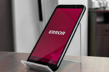 Wall Mural - Black smartphone with error message on the screen. Concept for displaying a smartphone malfunction