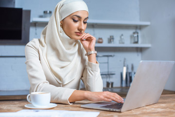 Wall Mural - beautiful young muslim woman using laptop at home