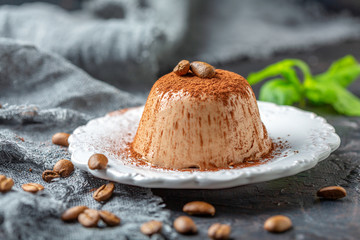 Wall Mural - Coffee Panna cotta with cocoa powder on a plate.