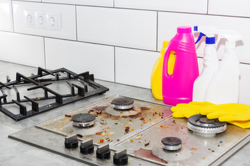 Cleaning a gas stove with kitchen utensils, household concepts, or hygiene and cleaning.