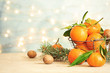 Christmas composition with ripe tangerines on table. Space for text