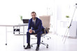 © New Africa - Young businessman sitting in comfortable office chair at workplace