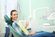 © New Africa - Happy young woman and dentist in modern clinic