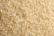 Raw parboiled rice as background, closeup view