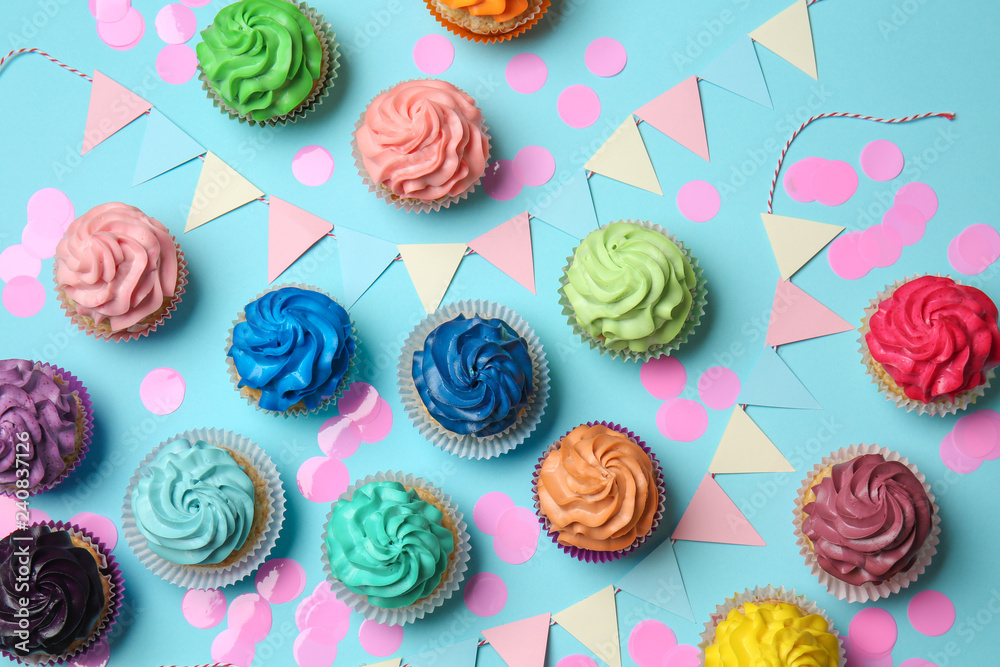 Different cupcakes on color background