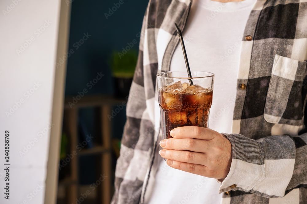 Woman drinking tasty soda at home