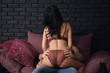 © Pixel-Shot - Passionate young couple on soft sofa