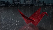 Red Crane Rain Features A City Landscape Background With Rain Falling Down And Splashing All Around A Origami Crane Made Out Of Red Paper That Have Been Left Outside.