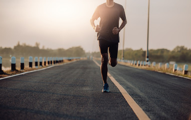 Wall Mural - Athlete runner feet running on road