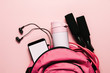 Sports bag and accessories on pink background