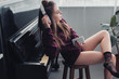 © LIGHTFIELD STUDIOS - beautiful girl with closed eyes and headphones on head sitting on chair in front of piano and holding smartphone in living room