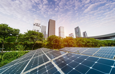 Wall Mural - ecological energy renewable solar panel plant with urban landscape landmarks