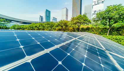 Wall Mural - ecological energy renewable solar panel plant with urban landscape landmarks