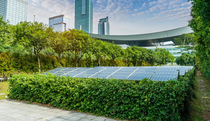Wall Mural - ecological energy renewable solar panel plant with urban landscape landmarks