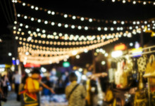 Abstract Blurred Background Of People Shopping At Night Market In The City