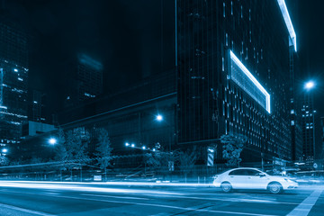 Poster - abstract image of blur motion of cars on the city road at night，Modern urban architecture in hangzhou, China