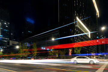 Poster - abstract image of blur motion of cars on the city road at night，Modern urban architecture in hangzhou, China