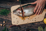 Fototapeta Tęcza - man cuts knife red fish for cooking