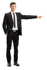 Poster - Young male adult in an elegant suit pointing to one direction