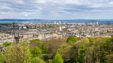 Fototapeta Na drzwi - Landscape of the city of Edinburgh in Scotland. Cityscape with medieval and modern architecture on a cloudy day, view from Calton Hill.