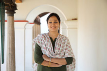 Cheerful Indian Woman Standing Infront Of House