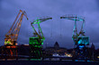 Colorfully illuminated antique cranes on the quay of Szczecin Łasztownia.