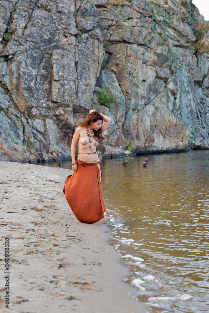 young beautiful naked Amazon woman on the sand river beach Stock Photo