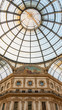 The cupola of Galleria Vittorio Emanuele from its center, with luxury decorations and the symmetric roof