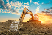 Excavator Work On Construction Site At Sunset
