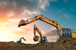 © ABCDstock - Three excavators work on construction site at sunset