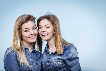 Two happy women friends wearing jeans outfit