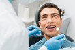 © LIGHTFIELD STUDIOS - cheerful african american man with during examination in dental clinic